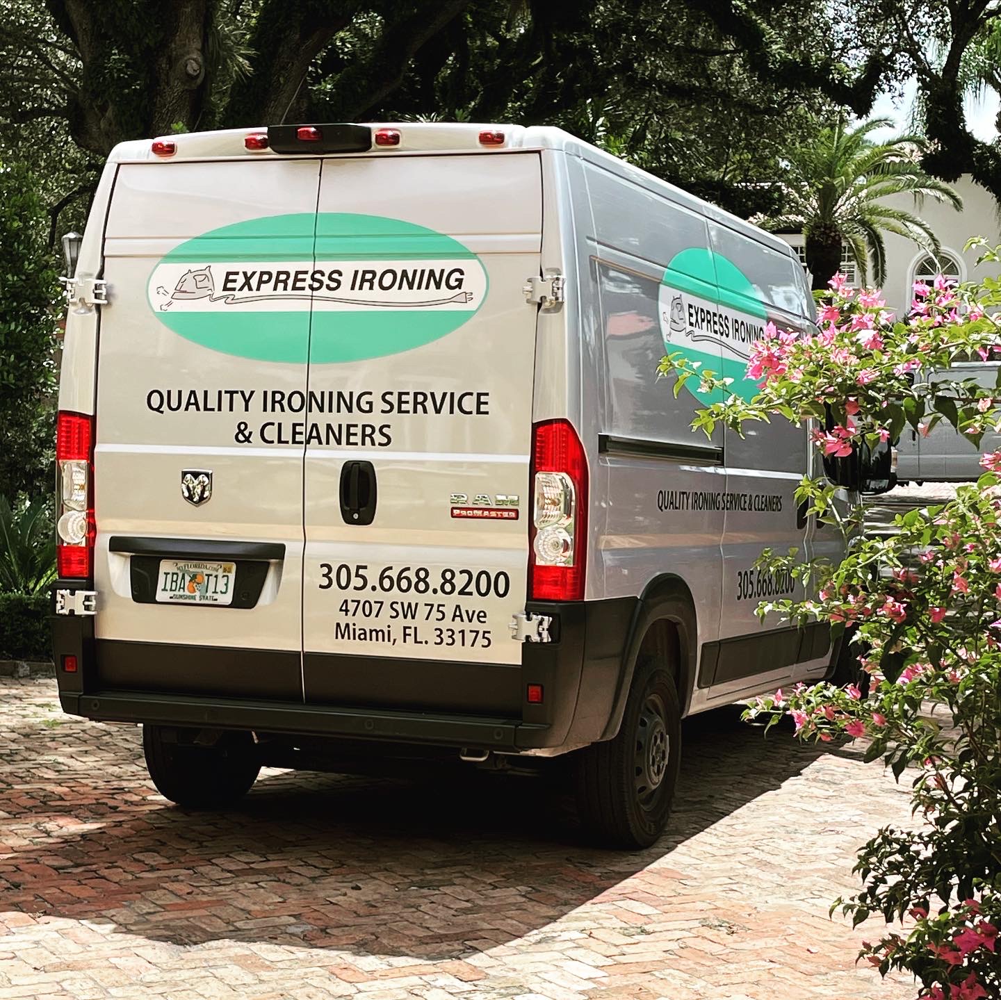 The Express Ironing delivery van parked on a Miami driveway, marked Quality Ironing Service & Cleaners